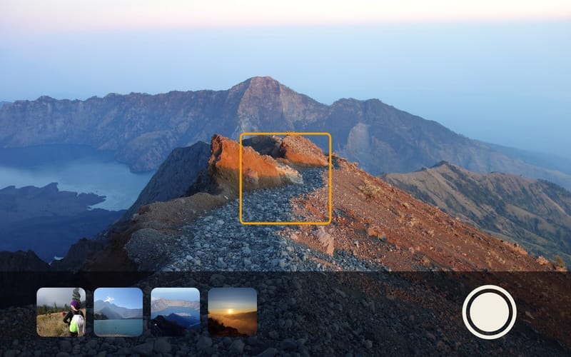 A summit ridge in the viewfinder with the shutter button and a strip of photos below