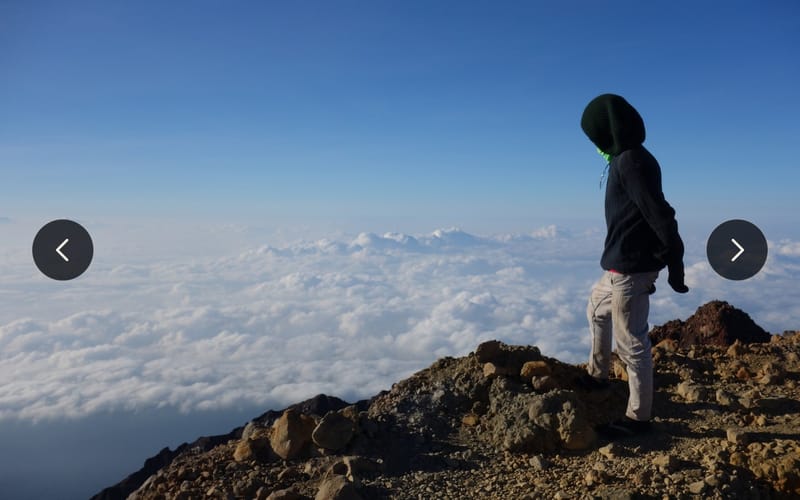 A summit photo with arrows on either side for flicking through