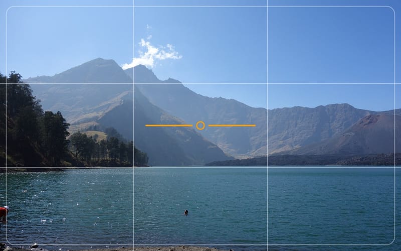 View across a crater lake with grid lines and a level, as in the app’s viewfinder